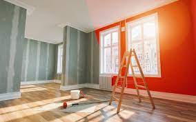 A professional painter carefully applies a fresh coat of paint to a residential wall in Dubai, showcasing meticulous attention to detail and expertise in residential painting services.